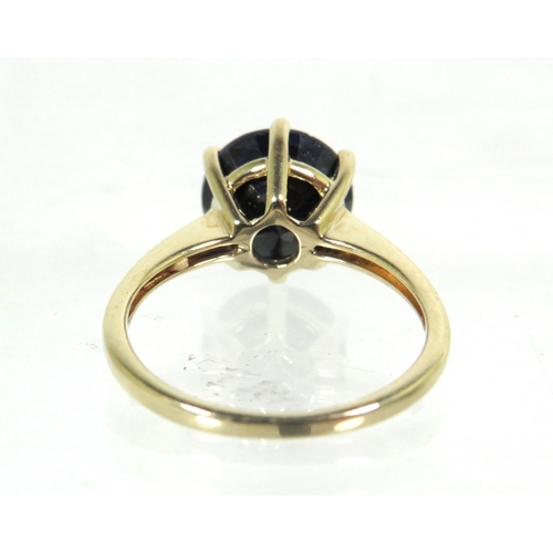 183 - 9ct Yellow Gold Ring set with a large Circular Sapphire which measures approx 100 in diameter.  Fing... 