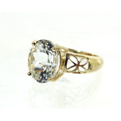 184 - 9ct Yellow Gold Ring with pierced Shoulders set with a large clear CZ Gemstone which measures approx... 