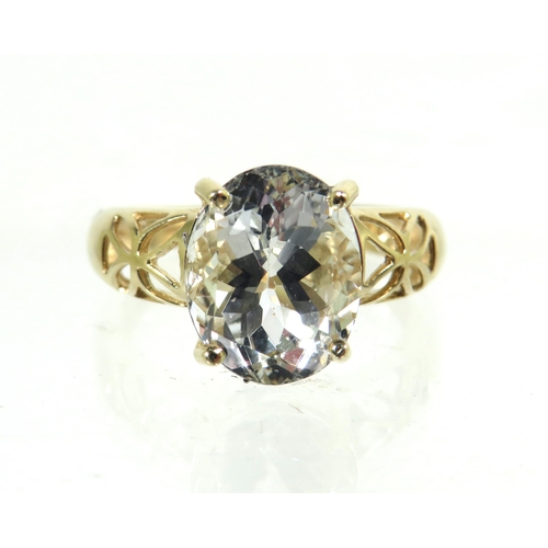 184 - 9ct Yellow Gold Ring with pierced Shoulders set with a large clear CZ Gemstone which measures approx... 