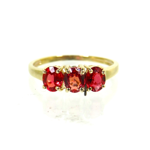 185 - 9ct Yellow Gold ring set with a trio of Ruby coloured CZ set Gemstones.   Finger size 'L'   1.5g