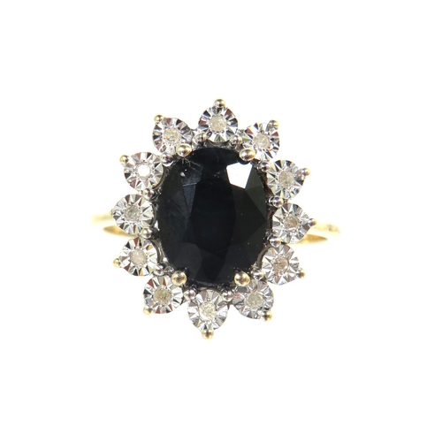 187 - 9ct Yellow Gold Ring set with a large Oval Sapphire ( 10 x 8 mm) surrounded by 12 illusion set Melee... 