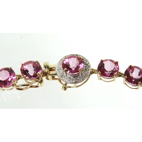 190 - 9ct Yellow Gold Braclet set with 24 6mm Circular Pink Sapphires with Sapphire to catch surrounded by... 