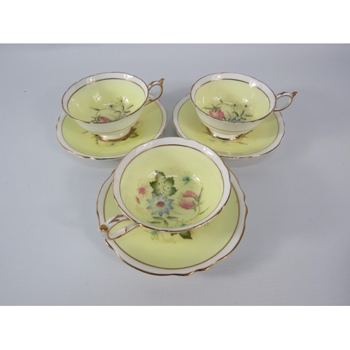 25 - Three Paragon china cups and saucers, yellow and white with floral decoration inside the bowl and on... 