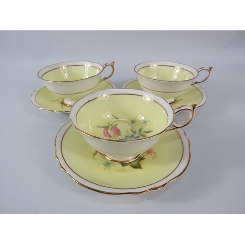 25 - Three Paragon china cups and saucers, yellow and white with floral decoration inside the bowl and on... 