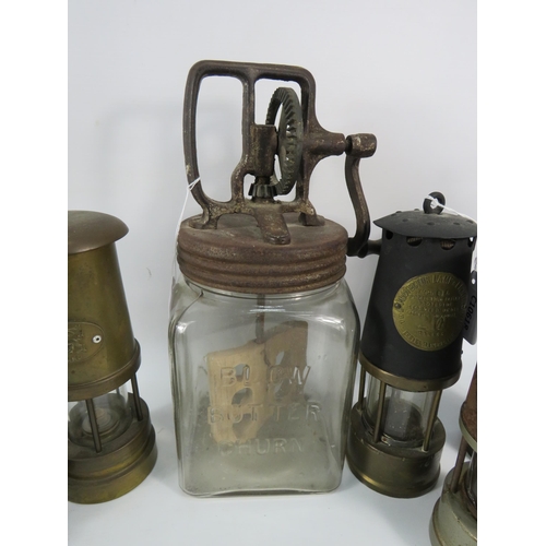 131 - Five vintage Miners lamps and a vintage glass butter churn.