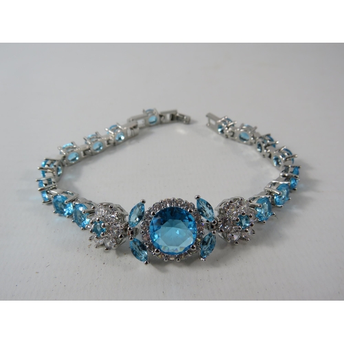 336 - 925 Silver bracelet set with lab created blue topaz and Cz stones, comes with extention.