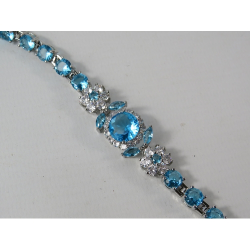 336 - 925 Silver bracelet set with lab created blue topaz and Cz stones, comes with extention.