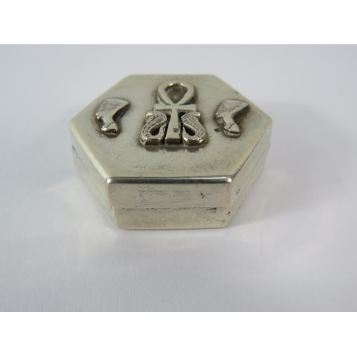 356 - 925 silver hexagon shaped pill box with Egyptian head and Ankh decoration to the top, 4cm by 3.5cm.