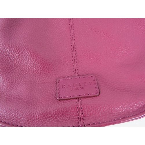 416 - Ladies Fuchsia leather Radley handbag with very little use.