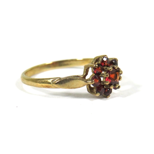 505 - 9ct Yellow Gold ring set with Garnets in a Flower Pattern. Finger size 'M'  1.4g