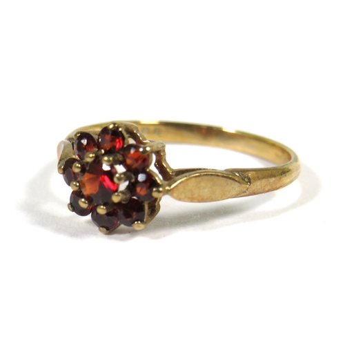 505 - 9ct Yellow Gold ring set with Garnets in a Flower Pattern. Finger size 'M'  1.4g