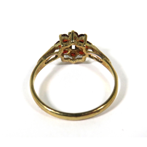 505 - 9ct Yellow Gold ring set with Garnets in a Flower Pattern. Finger size 'M'  1.4g