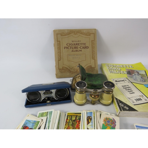 523 - Two pairs of vintage opera binoculars and a selection cigarette and tea cards.