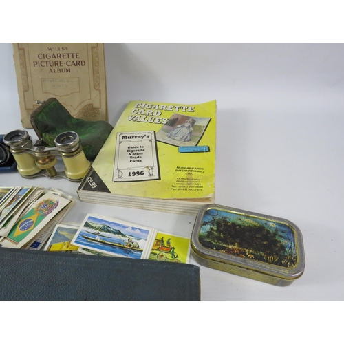 523 - Two pairs of vintage opera binoculars and a selection cigarette and tea cards.