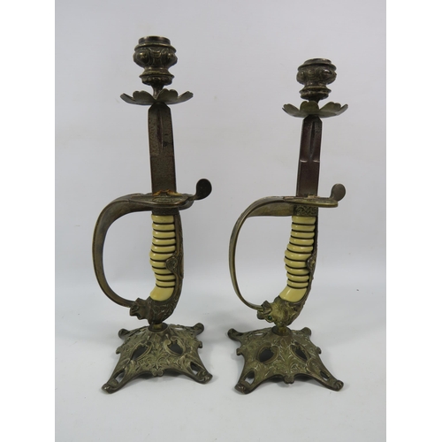 723 - Pair of c1920s WW1 Imperial German Navy Lions Head Sword candle holders, The lions have one green an... 