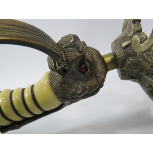 723 - Pair of c1920s WW1 Imperial German Navy Lions Head Sword candle holders, The lions have one green an... 