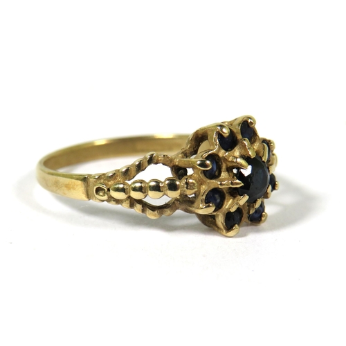 529A - 9ct Yellow Gold Ring set with Sapphires in a Flower pattern.  Finger size 'L-5'   1.8g