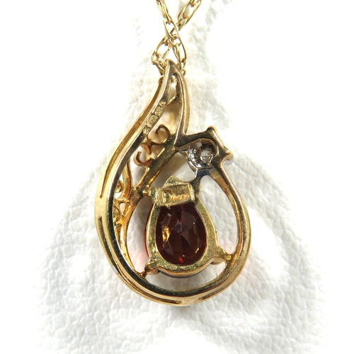 541A - 9ct Yellow Gold Pendant set with an Almond Shaped Garnet with tiny Diamond above. Hung on a 18 inch ... 