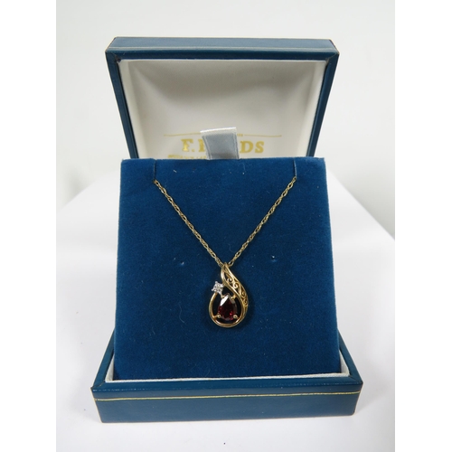 541A - 9ct Yellow Gold Pendant set with an Almond Shaped Garnet with tiny Diamond above. Hung on a 18 inch ... 