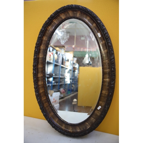 797 - Oval Framed Antique mirror which measures 32 x 21 inches. See photos.