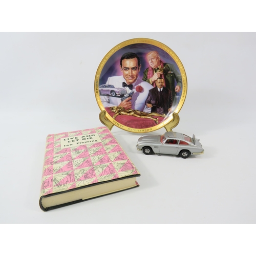 180a - James Bond lot to include a Corgi 007 Aston Martin DB5, Live and let die book and a plate.