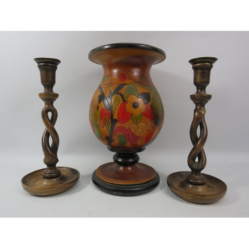 1111 - Large carved wooded vase and a pair of twisted carved wood candlesticks, the vase measures 12