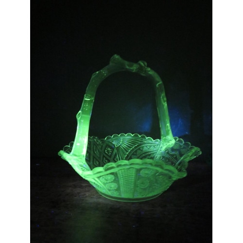 67 - Two Victorian uranium glass baskets by Davidson and Greener and a black glass stand. The largest mea... 