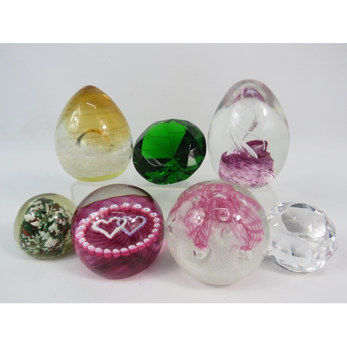 103 - Seven art glass paperweights including three by Caithness.