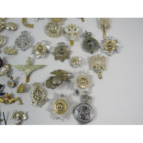 133 - Large selection of mainly reproduction military cap badges plus some enamel pin badges.