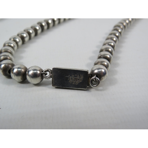 162 - Mexican 925 silver beaded necklace and solid 925 silver hinged bracelet. Total weight 109.7 grams