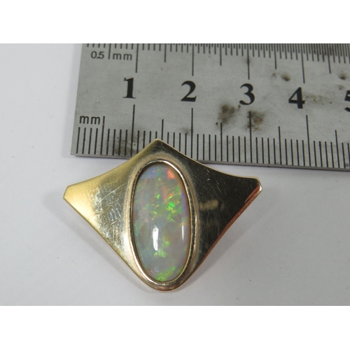 272 - 9ct Yellow Gold Brooch/ Pendant set with an Oval Opal which measures 19 x 9 mm.  Hallmarked for Lond... 