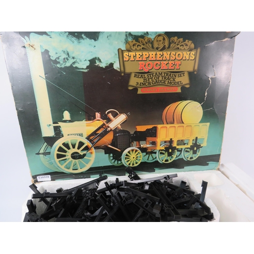 1055 - Hornby Railways Stephenson Rocket steam train set with 25ft of Track, Box is Tatty.