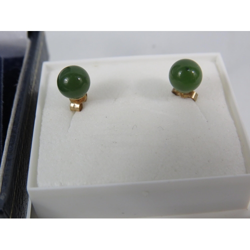 173 - Two Pairs of 9ct Ear studs, one pair set with Amber, the other set with Jade/ Neophrite.   See photo... 