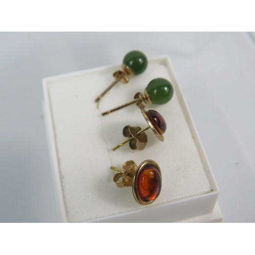 173 - Two Pairs of 9ct Ear studs, one pair set with Amber, the other set with Jade/ Neophrite.   See photo... 