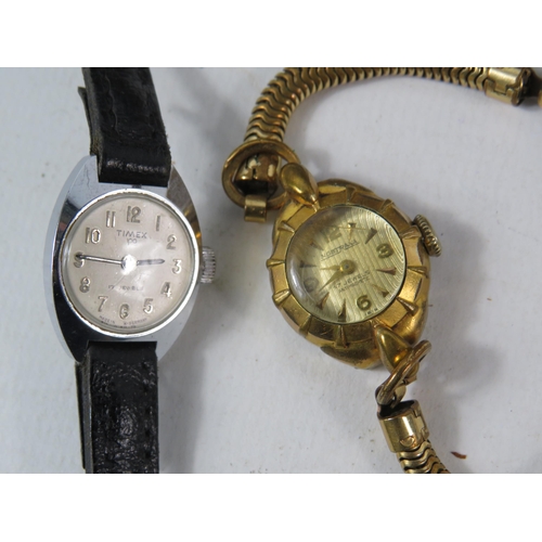 181 - Two Vintage ladies mechanical wristwatches and a vintage leather wallet with contents.