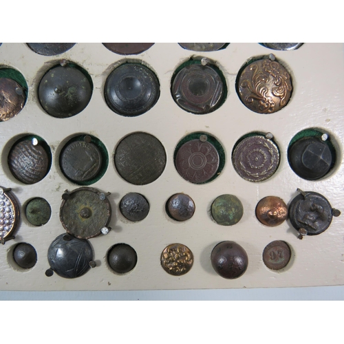 357 - Large selection of antique buttons from metal detecting displayed on a board.