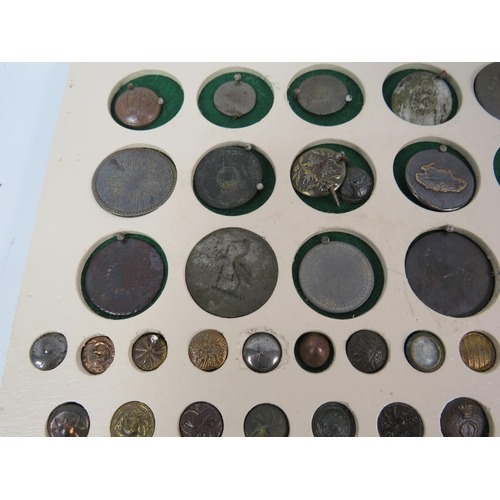 357 - Large selection of antique buttons from metal detecting displayed on a board.