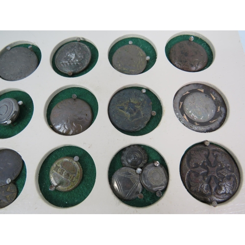 357 - Large selection of antique buttons from metal detecting displayed on a board.