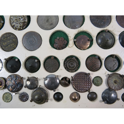 357 - Large selection of antique buttons from metal detecting displayed on a board.