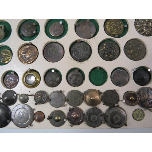 357 - Large selection of antique buttons from metal detecting displayed on a board.