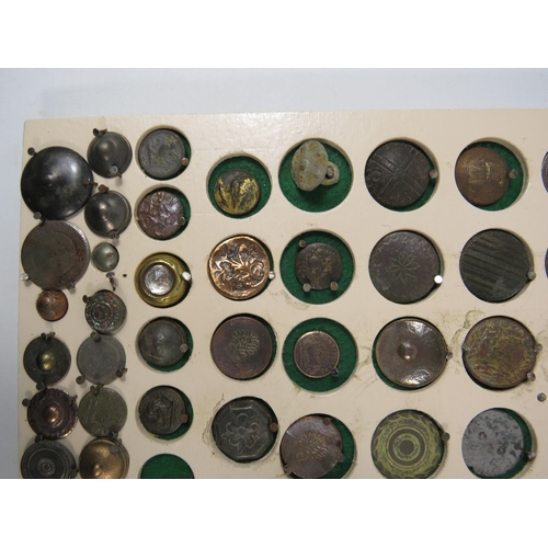 357 - Large selection of antique buttons from metal detecting displayed on a board.