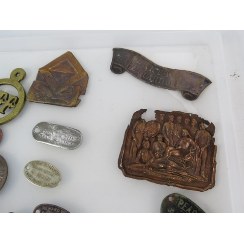 364 - Various antique metal detecting finds plaques and tags, including one from WW1 Ship HMS Minotaur.