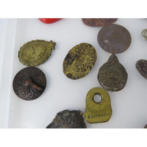 364 - Various antique metal detecting finds plaques and tags, including one from WW1 Ship HMS Minotaur.