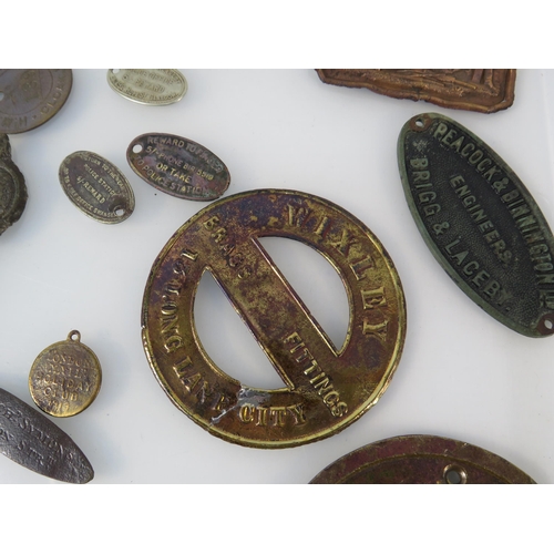 364 - Various antique metal detecting finds plaques and tags, including one from WW1 Ship HMS Minotaur.