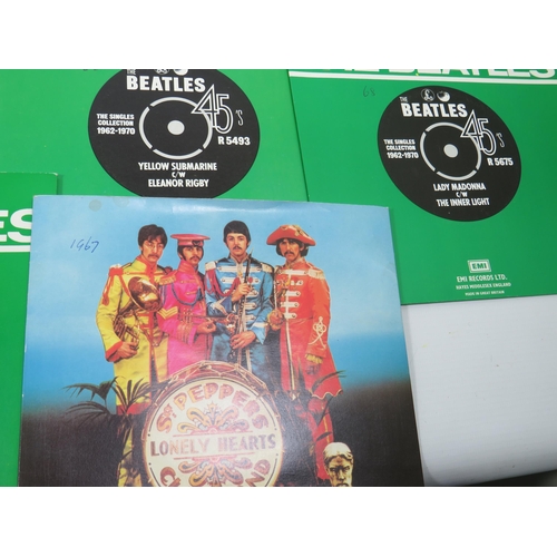 299 - Boxed Collection of 24 Vinyl 45's Beatles records with collectors box. All in sleeves and appear to ... 