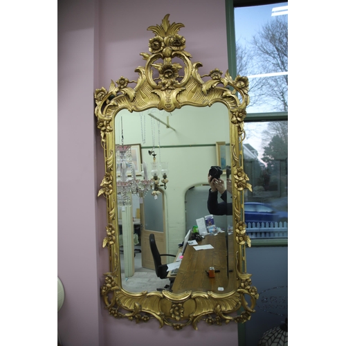 948 - Large modern Ornate mirror in the French style with gilded frame and bevelled glass. Measures approx... 