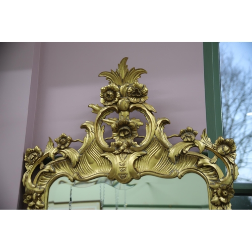 948 - Large modern Ornate mirror in the French style with gilded frame and bevelled glass. Measures approx... 