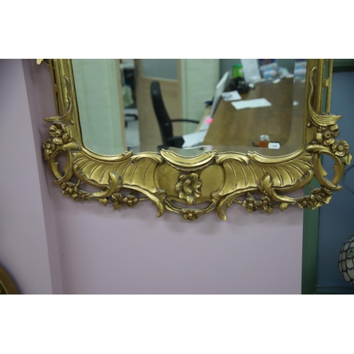 948 - Large modern Ornate mirror in the French style with gilded frame and bevelled glass. Measures approx... 