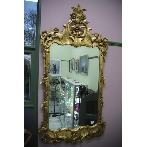 948 - Large modern Ornate mirror in the French style with gilded frame and bevelled glass. Measures approx... 