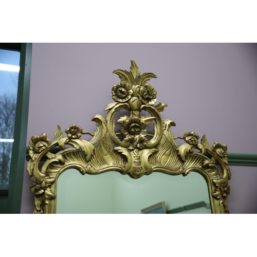 949 - Large modern Ornate mirror in the French style with gilded frame and bevelled glass. Measures approx... 